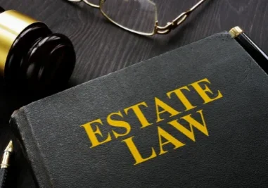 Estate law book with gavel and glasses.